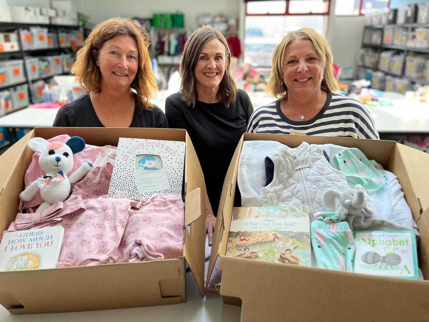 3 volunteers from Tassie Mums with boxes of clothing